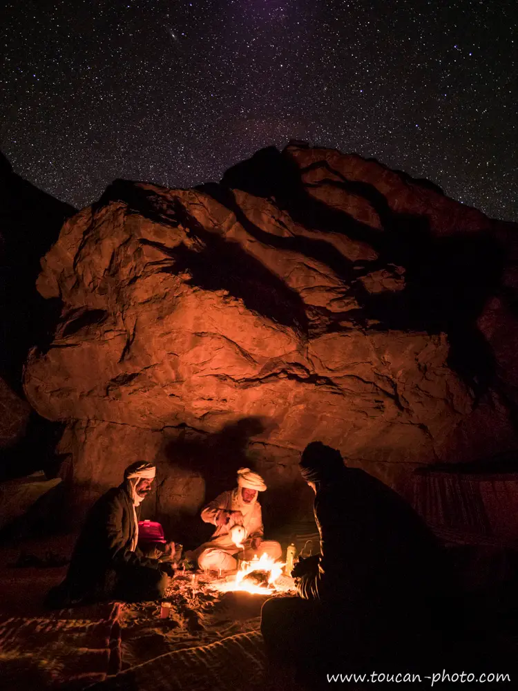 A campfire under a star-filled desert sky near Djanet, Algeria