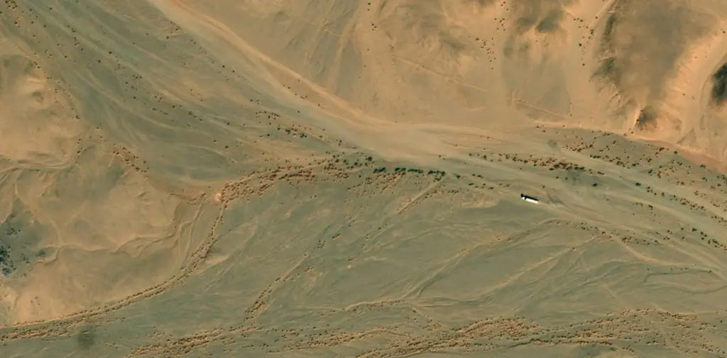 The road ending and open Sahara desert beginning beyond Djanet, Algeria